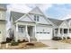 Beautiful home showcasing a welcoming porch with stone accents and a two-car garage at 1253 Barreto Dr, Wendell, NC 27591