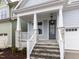 Inviting porch with stone pillars, detailed railings, and a stylish front door at 1253 Barreto Dr, Wendell, NC 27591