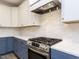 Modern kitchen features white and blue cabinets, stainless steel appliances, and subway tile backsplash at 1253 Barreto Dr, Wendell, NC 27591