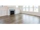 Cozy living room with fireplace, built-in cabinets, and large windows at 1253 Barreto Dr, Wendell, NC 27591