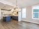 Open floor plan connects kitchen and dining area, featuring hardwood floors and natural light at 1253 Barreto Dr, Wendell, NC 27591