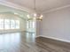 Spacious living room with vaulted ceiling, large windows, and elegant chandelier at 1253 Barreto Dr, Wendell, NC 27591
