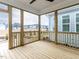 Spacious screened porch with wood floors and view of the neighborhood at 1253 Barreto Dr, Wendell, NC 27591