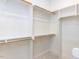Spacious walk-in closet with built-in shelving and wooden rods for optimal storage at 1253 Barreto Dr, Wendell, NC 27591