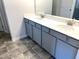Modern bathroom with double sink vanity, quartz countertop, and gray cabinetry at 158 Citizens Ct # 32, Four Oaks, NC 27524