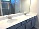 Modern bathroom with double sink vanity, quartz countertop, and tiled shower at 158 Citizens Ct # 32, Four Oaks, NC 27524