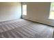 Bright bedroom featuring neutral walls, carpeted floors, and natural light from two windows at 158 Citizens Ct # 32, Four Oaks, NC 27524