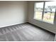 Bedroom with neutral walls, carpeted floors, and a window overlooking the neighborhood at 158 Citizens Ct # 32, Four Oaks, NC 27524