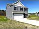 Side view of a gray, two story home featuring an attached two car garage and manicured lawn at 158 Citizens Ct # 32, Four Oaks, NC 27524
