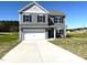 Two story home with gray siding, black shutters and a two car garage on a sunny day at 158 Citizens Ct # 32, Four Oaks, NC 27524