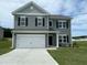 Attractive two-story home with gray siding, black shutters, and a spacious two-car garage on a green lawn at 158 Citizens Ct # 32, Four Oaks, NC 27524