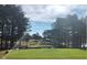 Scenic golf course view featuring a green, water and tall trees against a blue sky at 158 Citizens Ct # 32, Four Oaks, NC 27524