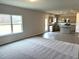 Open concept kitchen and living room with an island and neutral color palette at 158 Citizens Ct # 32, Four Oaks, NC 27524