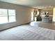 Open-concept living room view highlighting adjacent kitchen and modern flooring at 158 Citizens Ct # 32, Four Oaks, NC 27524