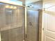 Modern bathroom featuring a glass-enclosed shower with gray tile and a white door at 346 Olivia Crossing Ct # 12, Four Oaks, NC 27524