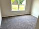 Bright bedroom with neutral carpet and a window view of the front yard at 346 Olivia Crossing Ct # 12, Four Oaks, NC 27524