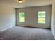 Comfortable bedroom with plush carpeting and large windows offering a scenic view at 346 Olivia Crossing Ct # 12, Four Oaks, NC 27524