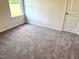 Cozy bedroom with plush neutral carpet, a window, and a white door at 346 Olivia Crossing Ct # 12, Four Oaks, NC 27524