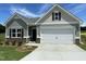 Beautiful one-story home with a two-car garage, dark shutters, and well-manicured front yard at 346 Olivia Crossing Ct # 12, Four Oaks, NC 27524