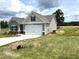Craftsman-style home with attached garage, concrete driveway, and well-maintained lawn and landscaping at 346 Olivia Crossing Ct # 12, Four Oaks, NC 27524