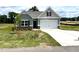 New construction craftsman-style home with brick detail, a well-manicured lawn, and attached garage at 346 Olivia Crossing Ct # 12, Four Oaks, NC 27524
