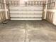 Spacious garage with a new white garage door and concrete flooring at 346 Olivia Crossing Ct # 12, Four Oaks, NC 27524