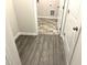 Hallway with wood-look flooring leading to laundry area at 346 Olivia Crossing Ct # 12, Four Oaks, NC 27524