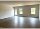 Bright living room with durable hard surface flooring and natural light from two windows at 346 Olivia Crossing Ct # 12, Four Oaks, NC 27524