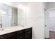 Well-lit bathroom with double sinks, a large mirror, and a tiled shower, offering a modern and functional space at 490 Barbour Farm Ln, Four Oaks, NC 27524