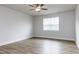 Cozy bedroom featuring hardwood floors, a ceiling fan, and a window that offers natural light at 490 Barbour Farm Ln, Four Oaks, NC 27524