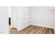 Functional closet with wood floors, a hanging rack, and shelving providing ample storage space at 490 Barbour Farm Ln, Four Oaks, NC 27524
