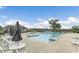 Community swimming pool with lounge chairs, tables, and umbrellas at 490 Barbour Farm Ln, Four Oaks, NC 27524