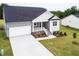 Beautiful home exterior featuring a stone-accented porch, manicured lawn, and attached two-car garage at 490 Barbour Farm Ln, Four Oaks, NC 27524
