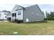 Beautiful exterior featuring gray siding, white trim, and a well-maintained lawn on a sunny day at 490 Barbour Farm Ln, Four Oaks, NC 27524