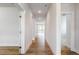 Hallway showcasing beautiful flooring, neutral paint, and natural light at 490 Barbour Farm Ln, Four Oaks, NC 27524