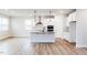 Bright, open kitchen with a center island, modern stainless steel appliances, and wood-look flooring at 490 Barbour Farm Ln, Four Oaks, NC 27524