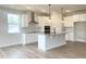 Modern kitchen featuring white cabinetry, stainless steel appliances, and a central island, perfect for cooking and entertaining at 490 Barbour Farm Ln, Four Oaks, NC 27524