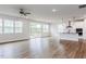 Bright living room showcasing hardwood floors, neutral walls, and an open layout that connects to the kitchen at 490 Barbour Farm Ln, Four Oaks, NC 27524
