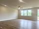 Spacious living room filled with natural light, featuring hardwood floors and a ceiling fan at 490 Barbour Farm Ln, Four Oaks, NC 27524