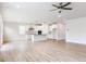 Bright open floor plan with a kitchen island, stainless appliances, and wood-look flooring at 490 Barbour Farm Ln, Four Oaks, NC 27524