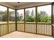 Inviting screened porch with wood flooring and views of a lush green backyard at 490 Barbour Farm Ln, Four Oaks, NC 27524