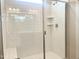 Modern shower with white subway tile, glass enclosure, and hexagon tile floor at 490 Barbour Farm Ln, Four Oaks, NC 27524