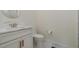 Clean bathroom with a marble vanity top, brushed nickel faucet, and a round mirror at 736 Golfers View Vw, Pittsboro, NC 27312