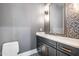 Powder room with black and white patterned wallpaper, dark vanity, and a large mirror at 736 Golfers View Vw, Pittsboro, NC 27312