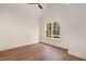 Well lit bedroom featuring hardwood floors, white trim and walls and a large window at 736 Golfers View Vw, Pittsboro, NC 27312