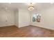 Bright bedroom with hardwood floors, crown molding, a modern light fixture, and a large window at 736 Golfers View Vw, Pittsboro, NC 27312