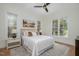 Bright bedroom with hardwood floors, a ceiling fan, and natural light from large windows at 736 Golfers View Vw, Pittsboro, NC 27312