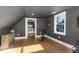 Bright exercise room with hardwood floors, storage cabinet, exercise bike, and a large window at 736 Golfers View Vw, Pittsboro, NC 27312