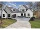 Beautiful two-story home with a brick and stone exterior and a curved driveway at 736 Golfers View Vw, Pittsboro, NC 27312