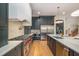 Gourmet kitchen featuring stainless steel appliances, a marble backsplash, and custom cabinetry at 736 Golfers View Vw, Pittsboro, NC 27312